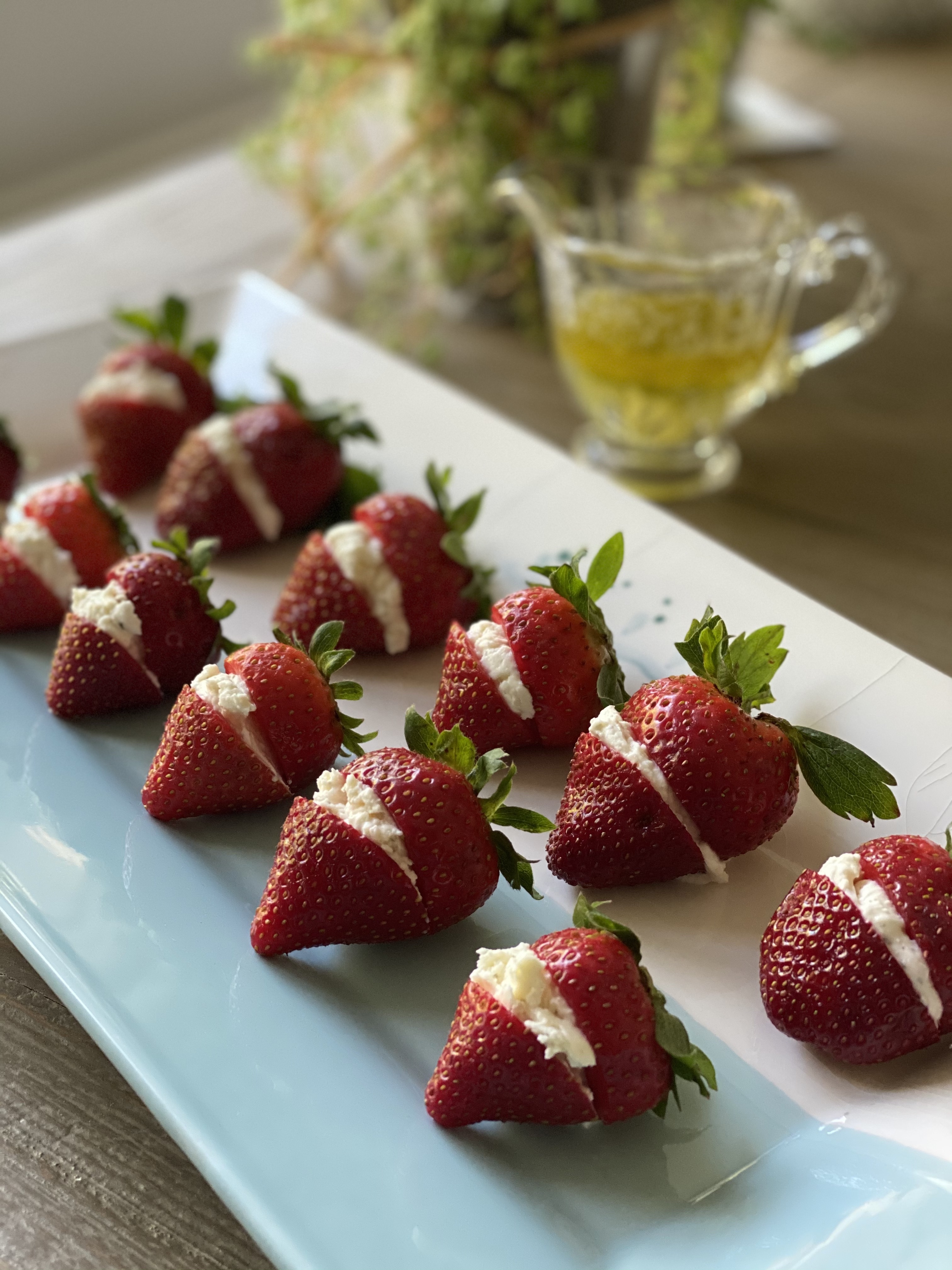 Strawberry Buttons Filled with an Herbed Goat Cheese Drizzled with a Lime Vinaigrette